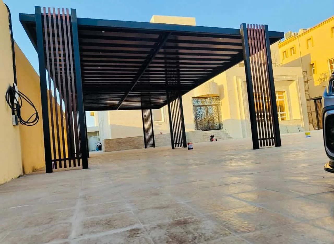 Completed dark metal pergola structure in a villa exterior